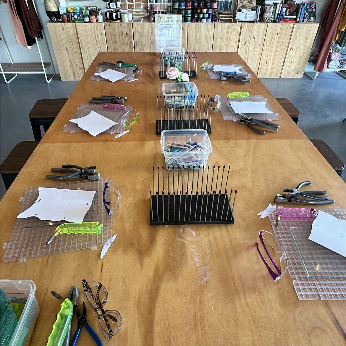 Wooden table with various tools and materials in a workshop setting